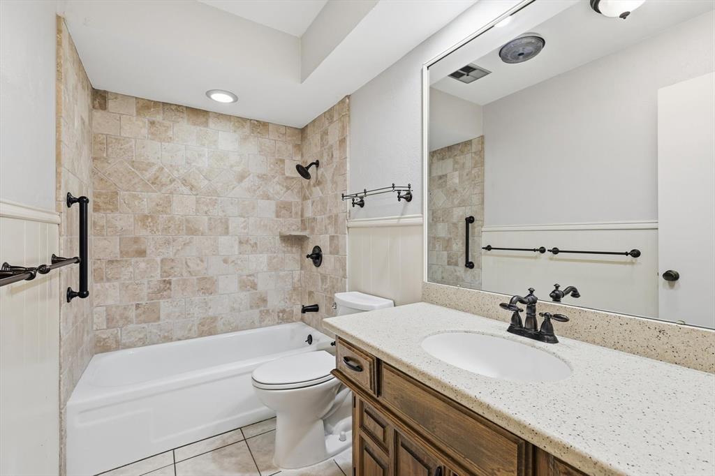 2505 Oak Manor Court Arlington, TX 76012 - Photo 16 of 23 a bathroom with a sink a toilet and shower