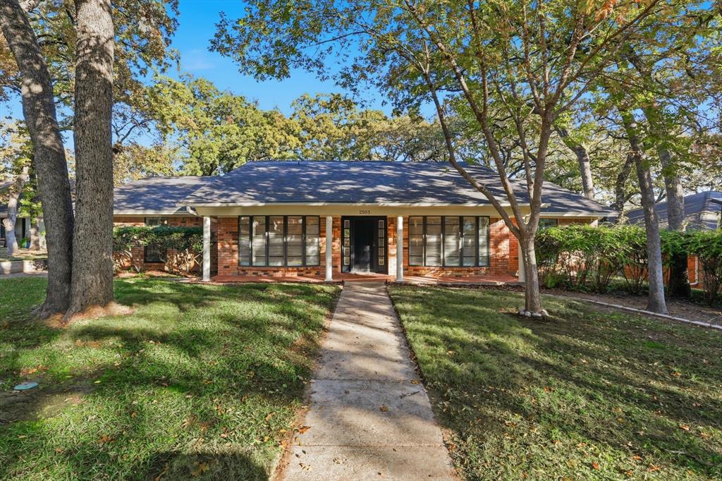 2505 Oak Manor Court Arlington, TX 76012 - Photo 2 of 23 a front view of a house with a garden
