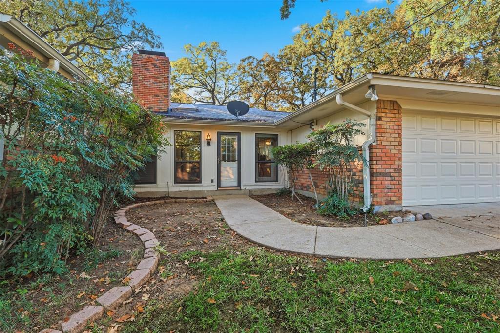 2505 Oak Manor Court Arlington, TX 76012 - Photo 21 of 23 a front view of a house with garden