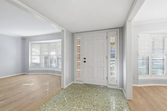 an empty room with windows and closet