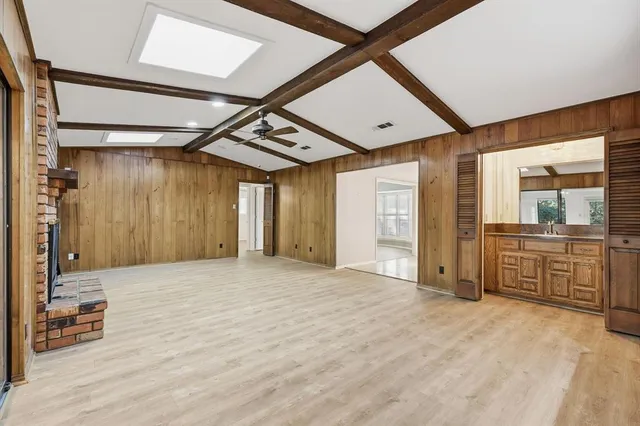 a view of a hallway with wooden cabinet