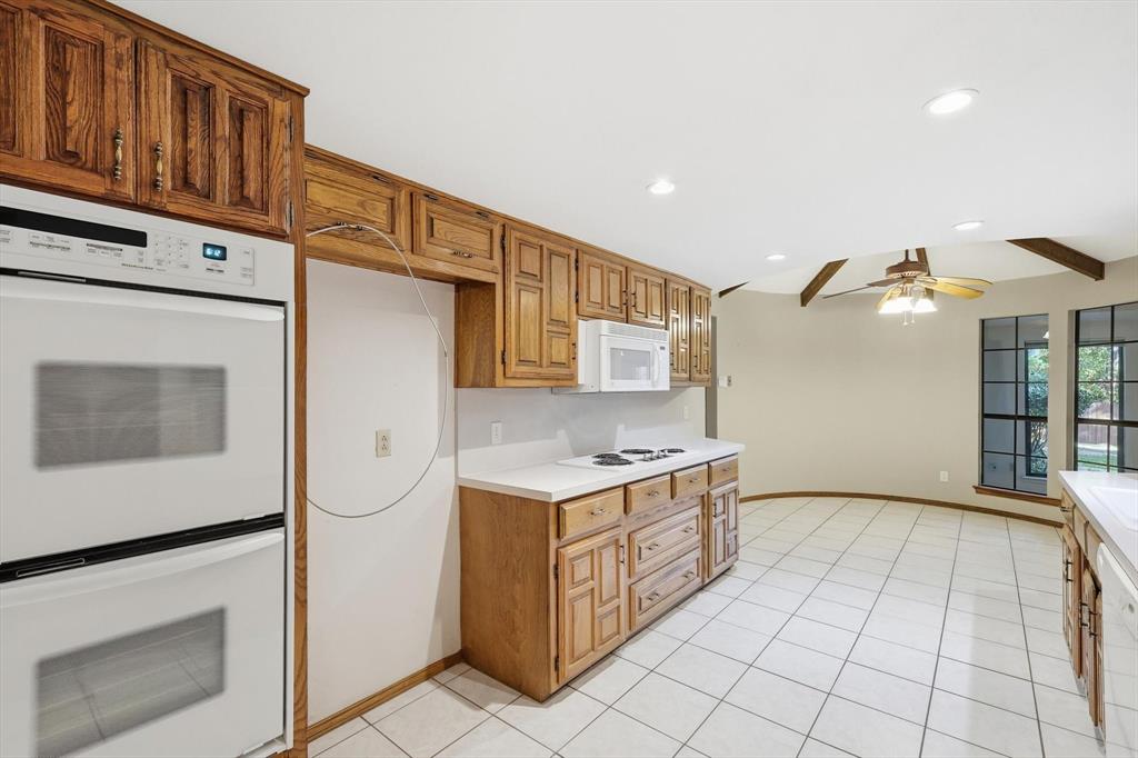 2505 Oak Manor Court Arlington, TX 76012 - Photo 8 of 23 a kitchen with stainless steel appliances granite countertop a stove a refrigerator and a cabinets