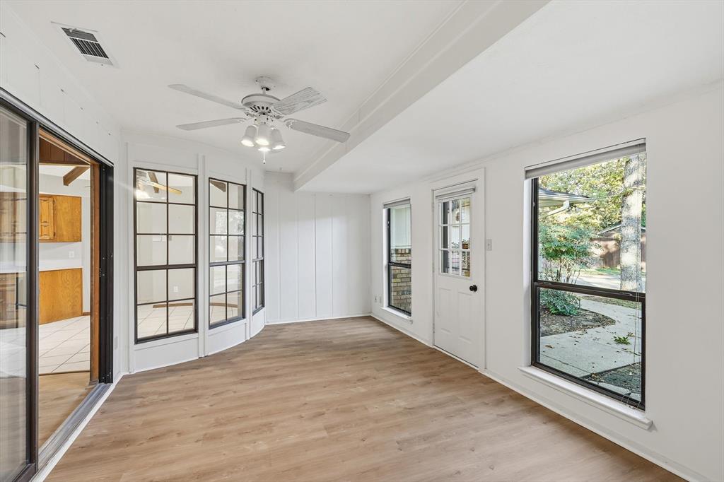 2505 Oak Manor Court Arlington, TX 76012 - Photo 10 of 23 wooden floor in an empty room with a window
