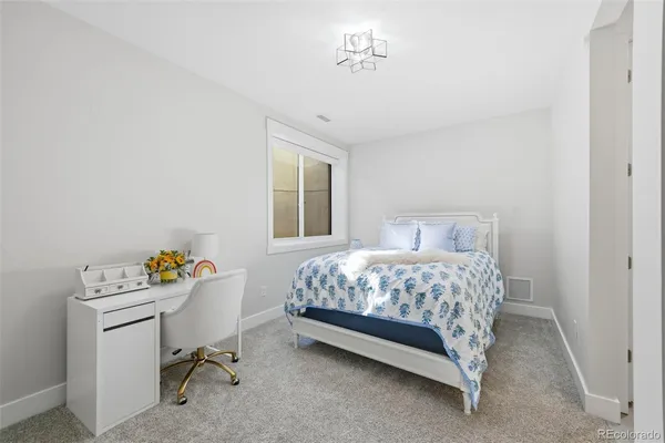 a bedroom with a bed and a table in it