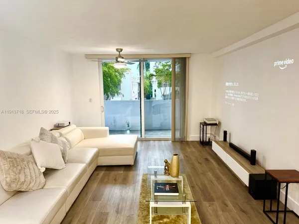 a living room with furniture and a large window