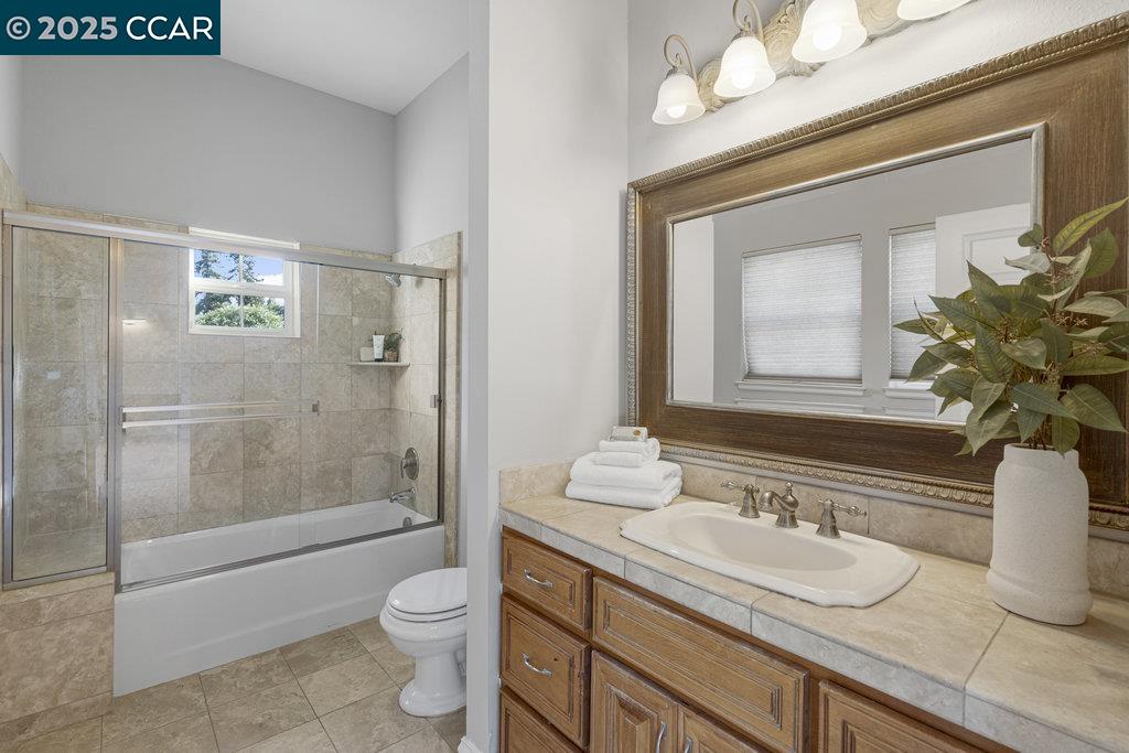 5655 Bruce Drive Livermore, CA 94551 - Photo 26 of 47 a bathroom with a granite countertop sink toilet and shower