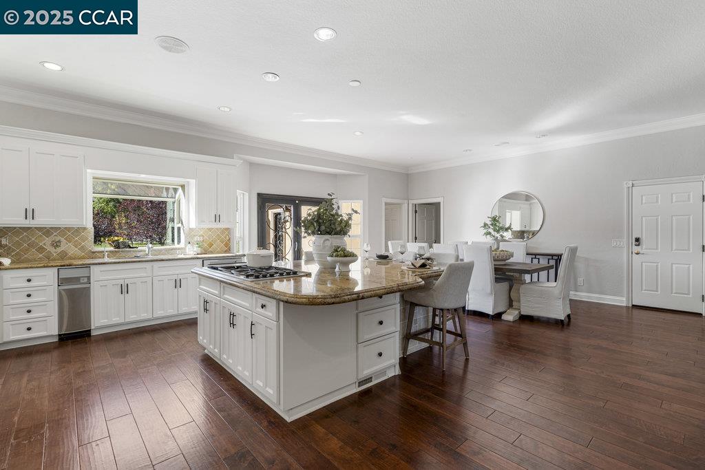 5655 Bruce Drive Livermore, CA 94551 - Photo 10 of 47 a kitchen with granite countertop a sink cabinets and wooden floor