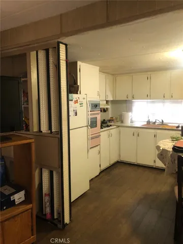 a kitchen with a sink appliances and cabinets