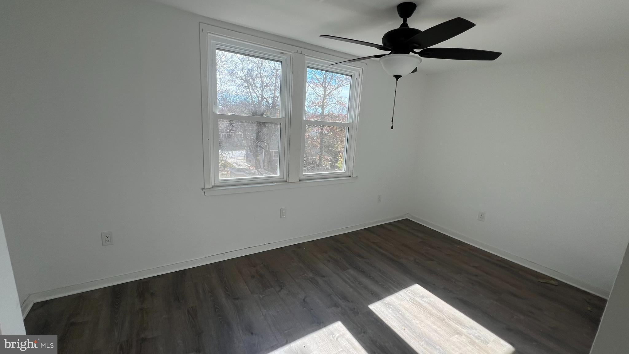 58 Chews Landing Road Clementon, NJ 08021 - Photo 17 of 21 an empty room with wooden floor ceiling fan and windows
