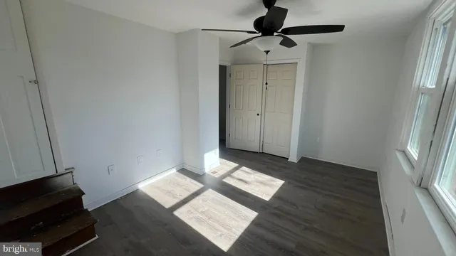 a view of an empty room and wooden floor