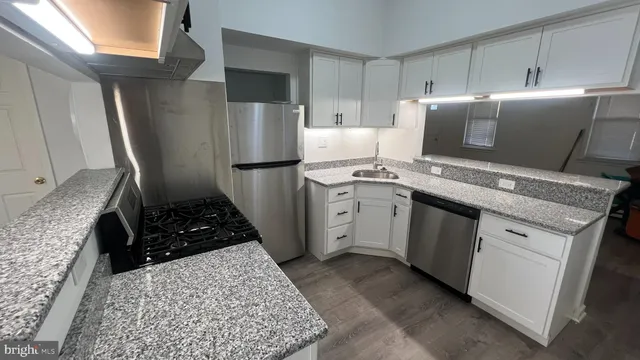 a kitchen with a sink stove and refrigerator