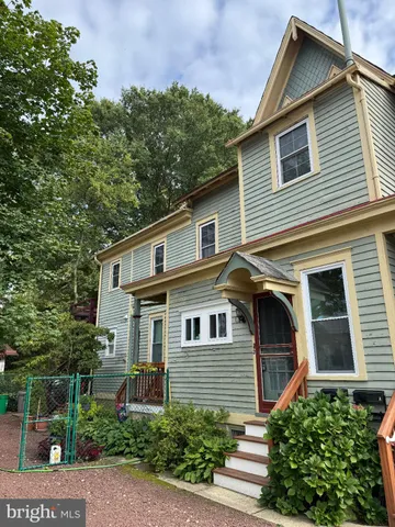 a front view of a house with plants