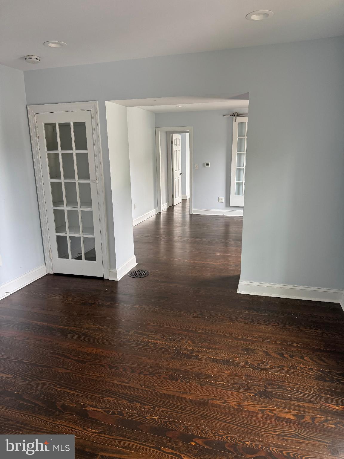 237 South Atlantic Avenue, Unit B Haddonfield, NJ 08033 - Photo 4 of 10 a view of an empty room with wooden floor and a window