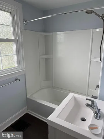a bathroom with a tub and a sink