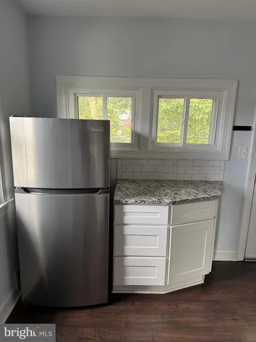a kitchen with a refrigerator and window