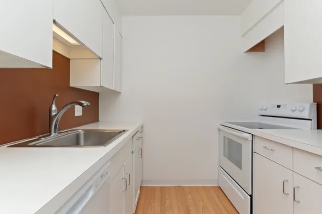 a kitchen with a sink and cabinets