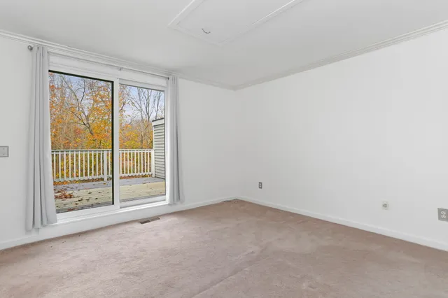 a view of an empty room with glass door