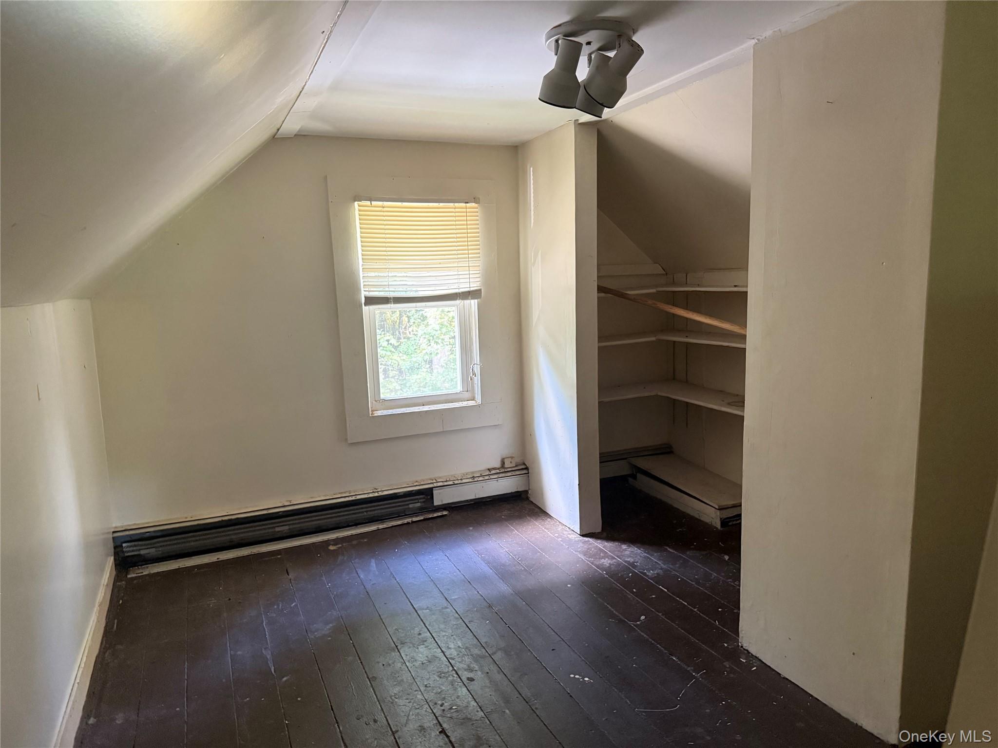3968 Old Crompond Road Cortlandt Manor, NY 10567 - Photo 16 of 17 Bonus room with dark wood finished floors, vaulted ceiling, baseboard heating, and a baseboard radiator