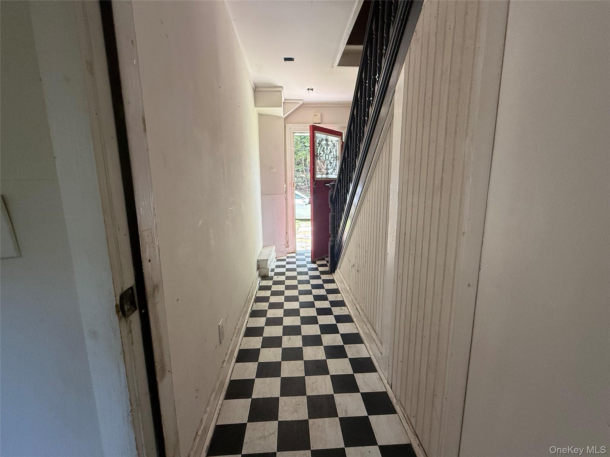 3968 Old Crompond Road Cortlandt Manor, NY 10567 - Photo 8 of 17 Hall featuring tile patterned floors, wooden walls, and stairway