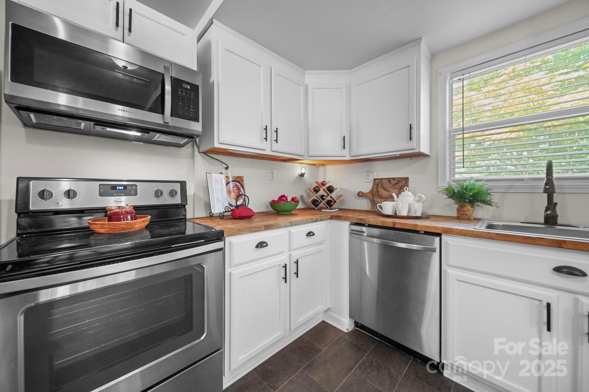 452 18th Street Cramerton, NC 28032 - Photo 12 of 35 a kitchen with white cabinets stainless steel appliances and sink
