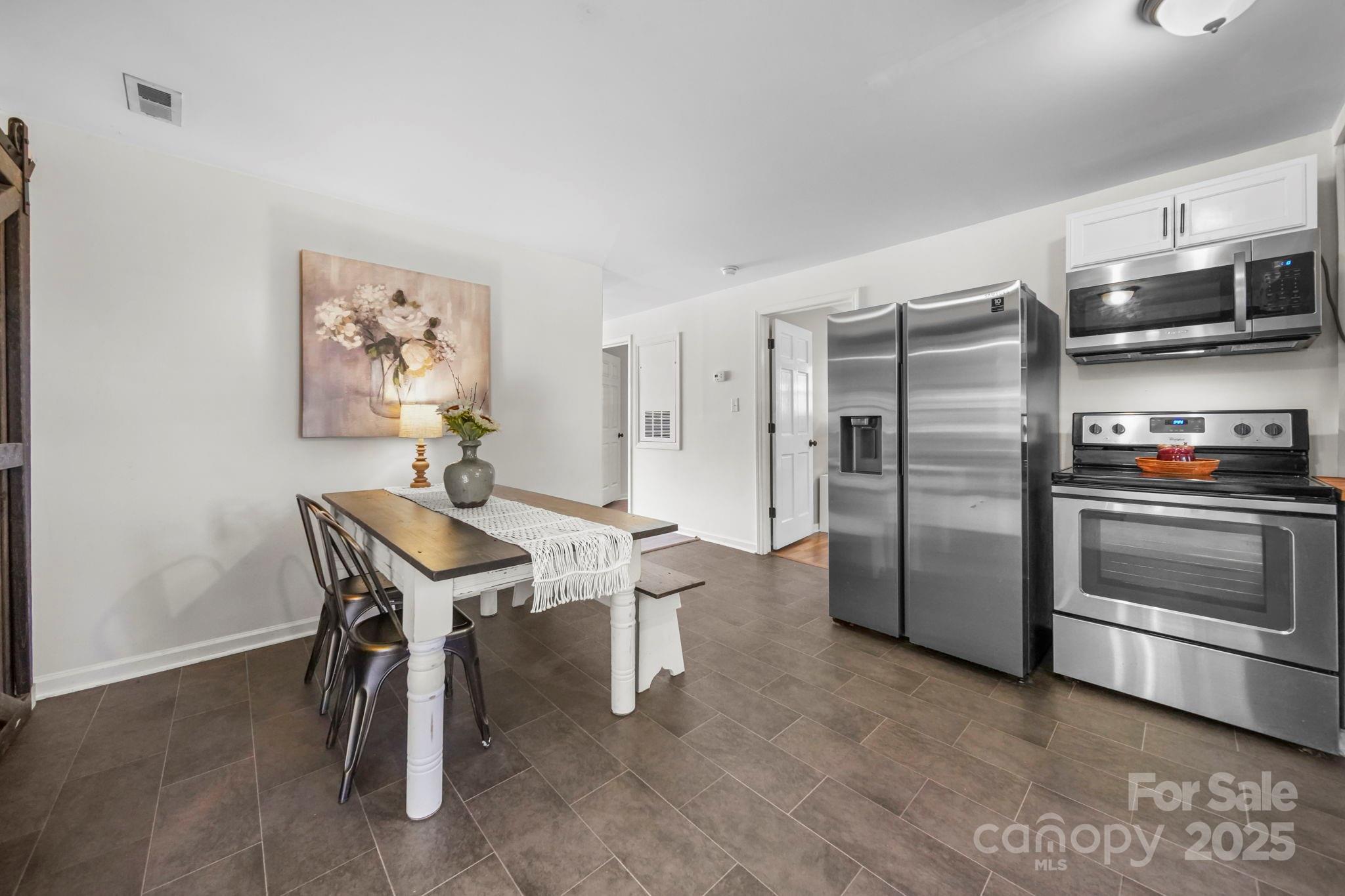 452 18th Street Cramerton, NC 28032 - Photo 14 of 35 a kitchen with stainless steel appliances a refrigerator and a stove top oven