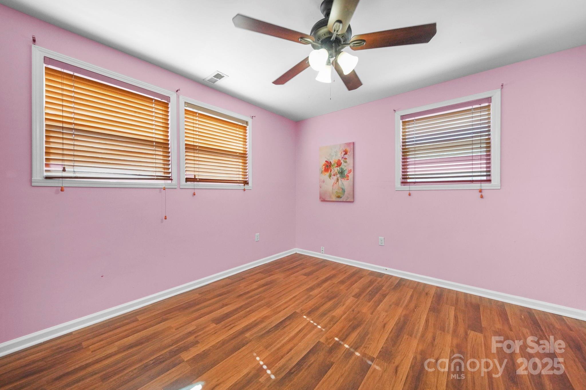 452 18th Street Cramerton, NC 28032 - Photo 25 of 35 a view of empty room with wooden floor and fan