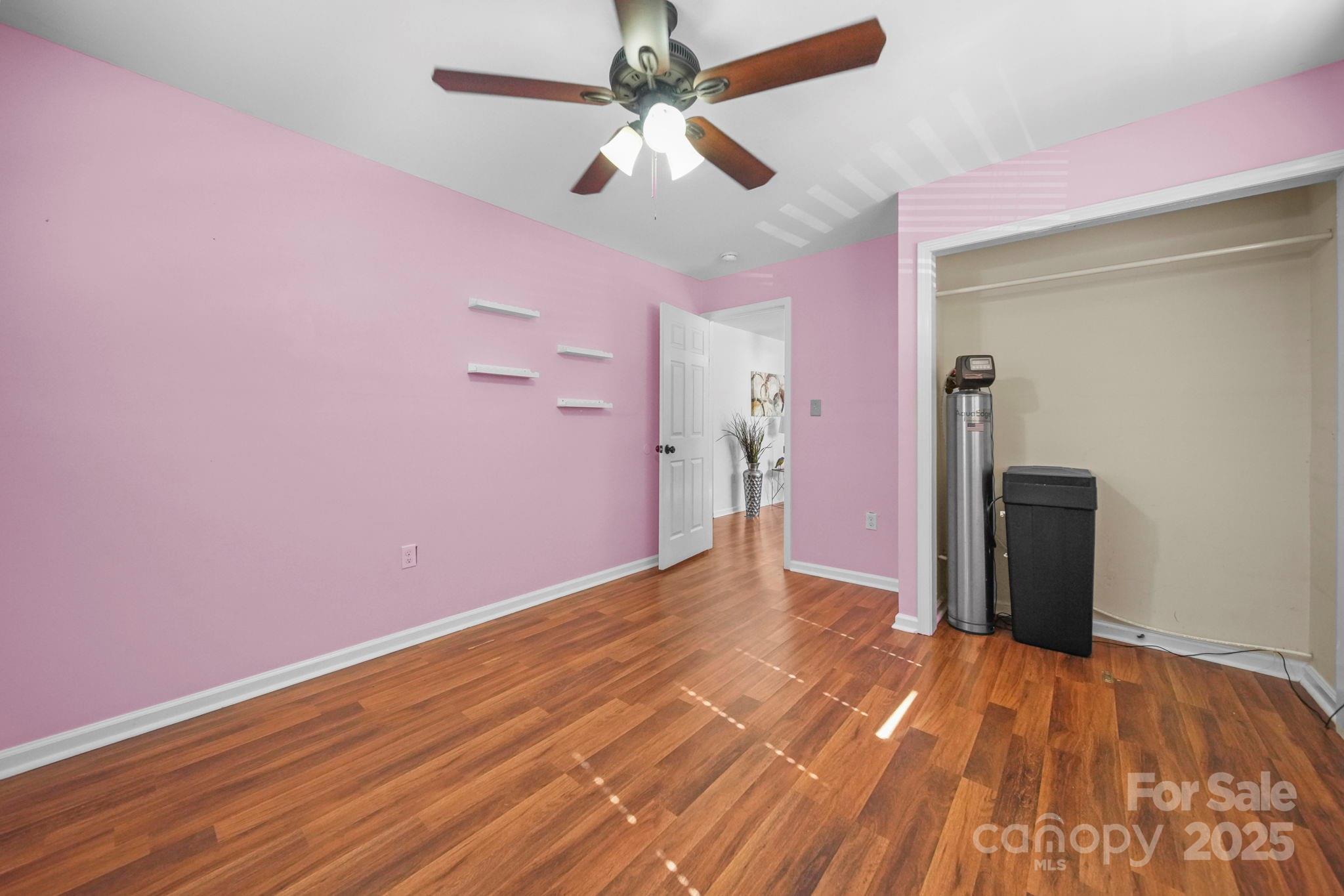 452 18th Street Cramerton, NC 28032 - Photo 27 of 35 a view of a livingroom with wooden floor and a ceiling fan