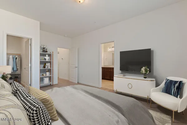 a bedroom with a bed and a flat screen tv