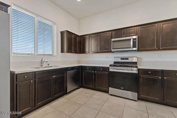 a kitchen with stainless steel appliances granite countertop a stove microwave and cabinets