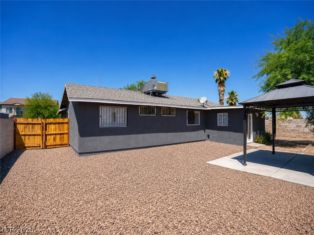 2870 South Sandhill Road Las Vegas, NV 89121 - Photo 24 of 64 An inviting backyard oasis offers a gravel expanse, covered patio, and a secure wooden fence.