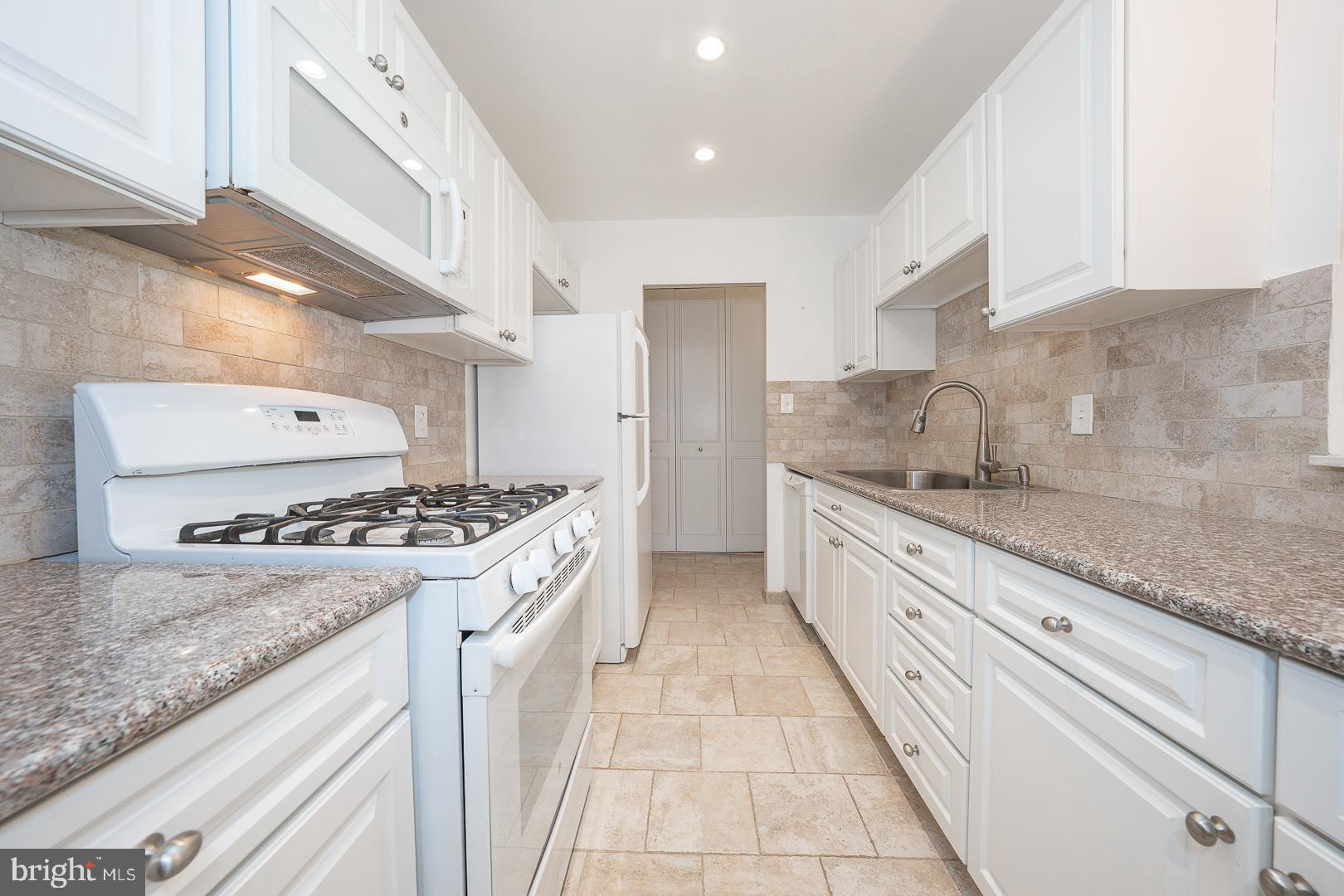 446 Drummers Lane Wayne, PA 19087 - Photo 12 of 27 a large kitchen with granite countertop a sink and a stove