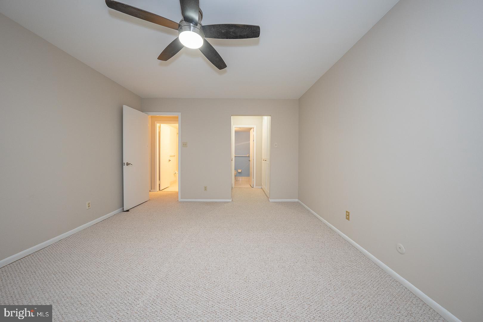 446 Drummers Lane Wayne, PA 19087 - Photo 17 of 27 an empty room with chandelier fan and windows