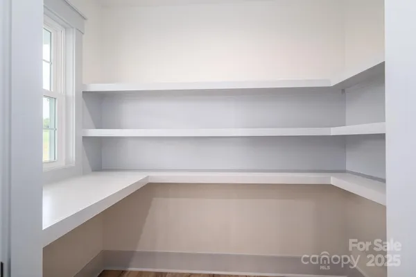 a kitchen with a refrigerator sink and cabinets
