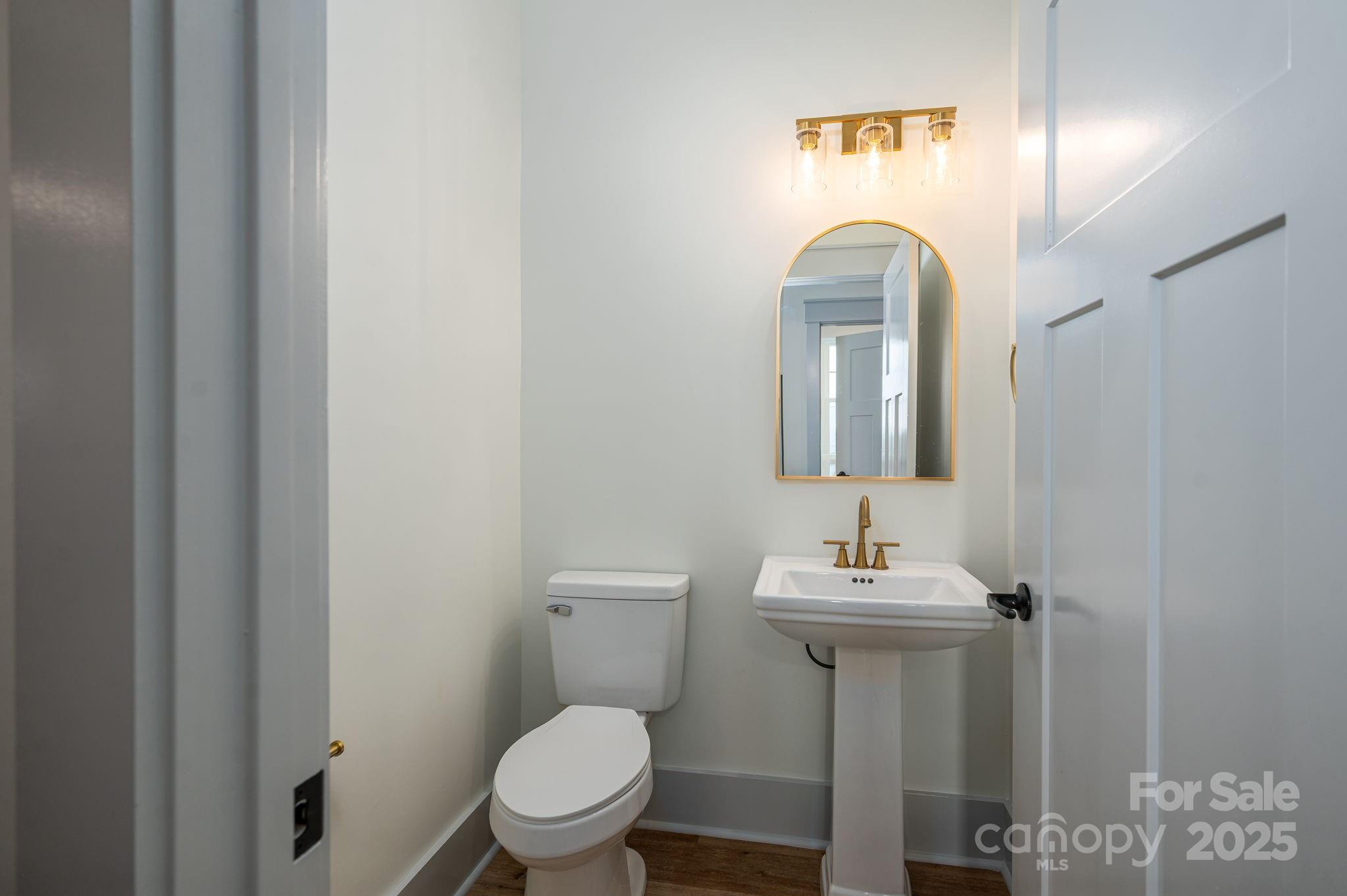 5384 Reepsville Road Vale, NC 28168 - Photo 23 of 44 a bathroom with a toilet sink and mirror