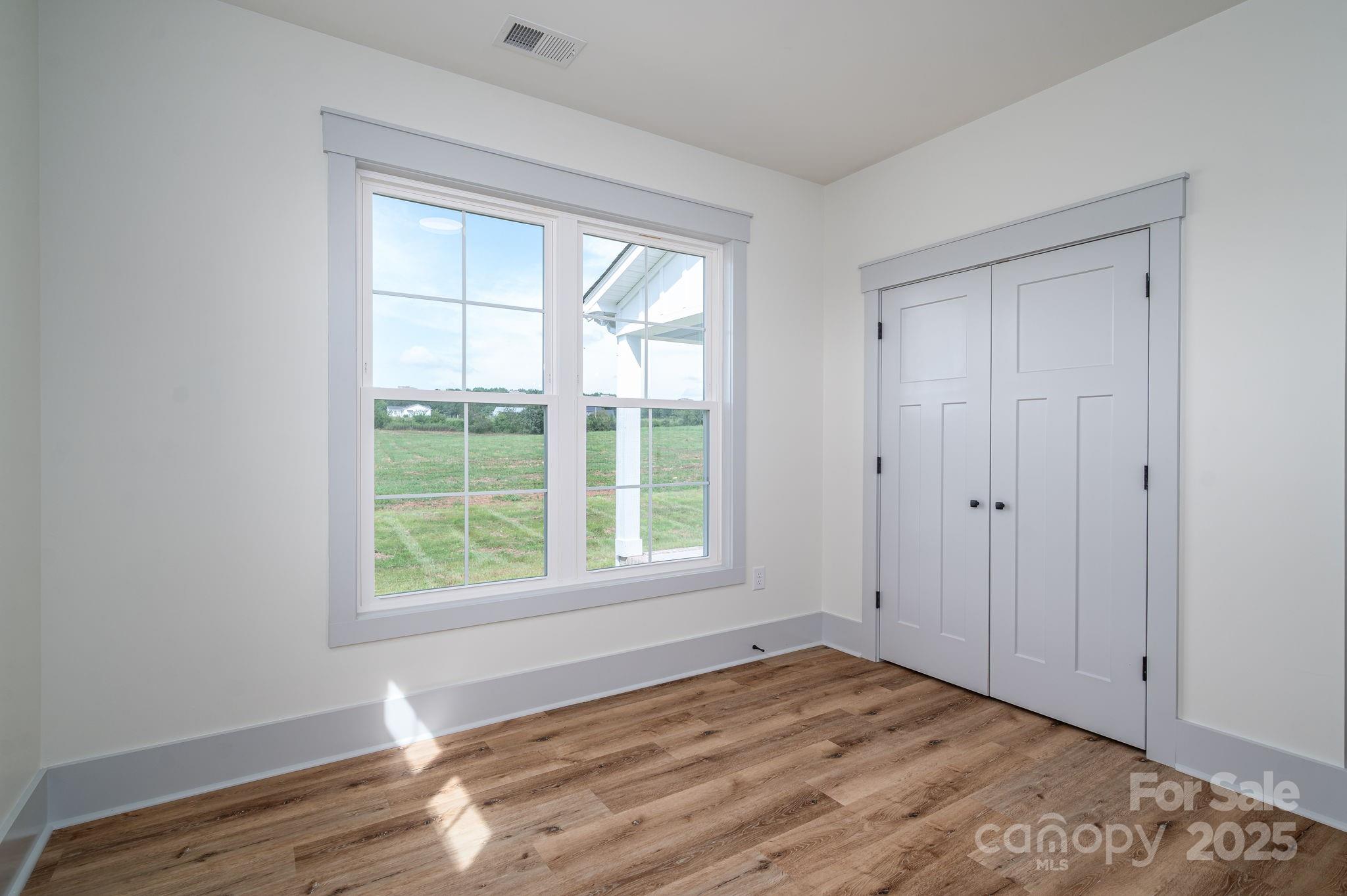 5384 Reepsville Road Vale, NC 28168 - Photo 26 of 44 a view of empty room with wooden floor and fan