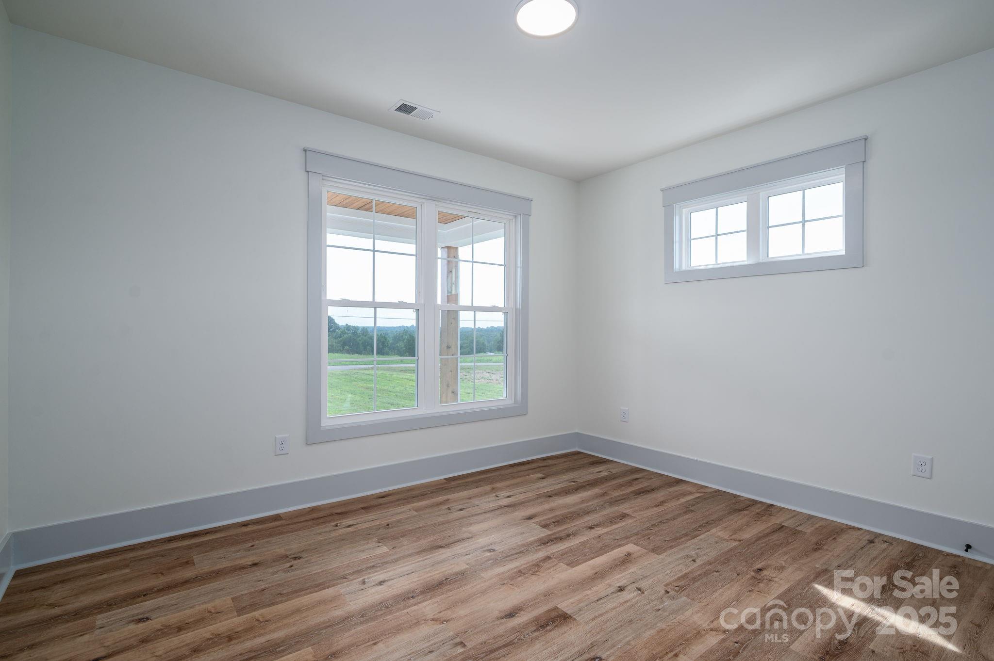 5384 Reepsville Road Vale, NC 28168 - Photo 29 of 44 a view of an empty room with wooden floor and a window