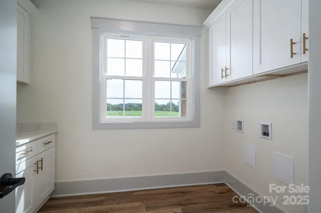 a kitchen with stainless steel appliances granite countertop white cabinets and a sink