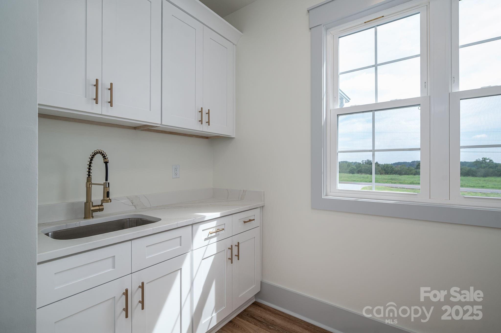 5384 Reepsville Road Vale, NC 28168 - Photo 32 of 44 a kitchen with stainless steel appliances granite countertop white cabinets and a sink