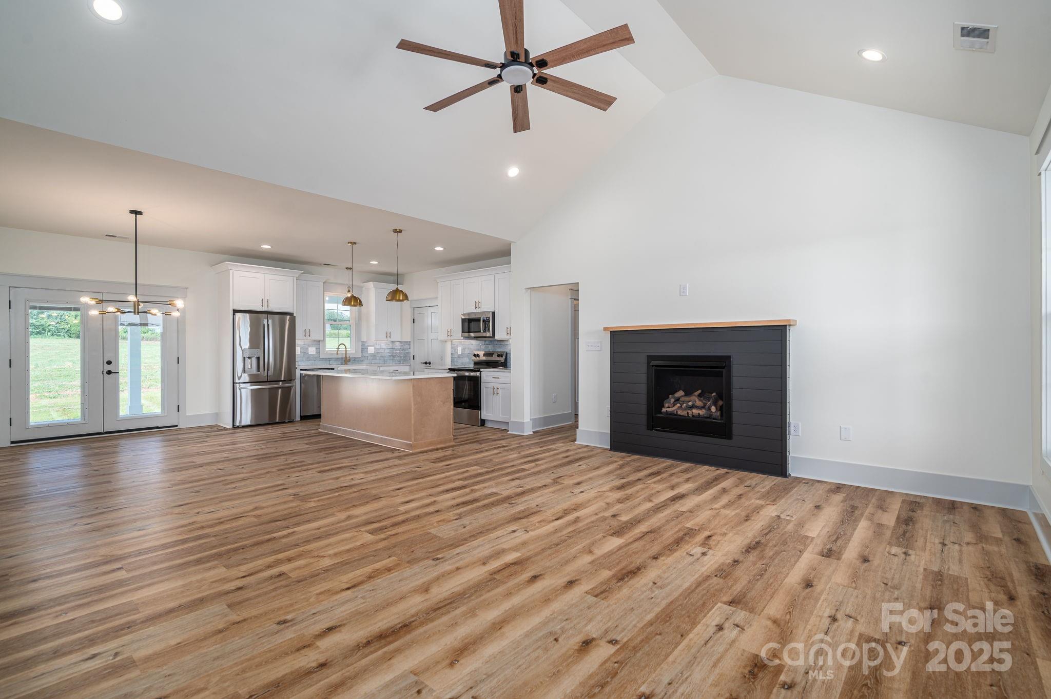 5384 Reepsville Road Vale, NC 28168 - Photo 7 of 44 a view of empty room with wooden floor and fireplace