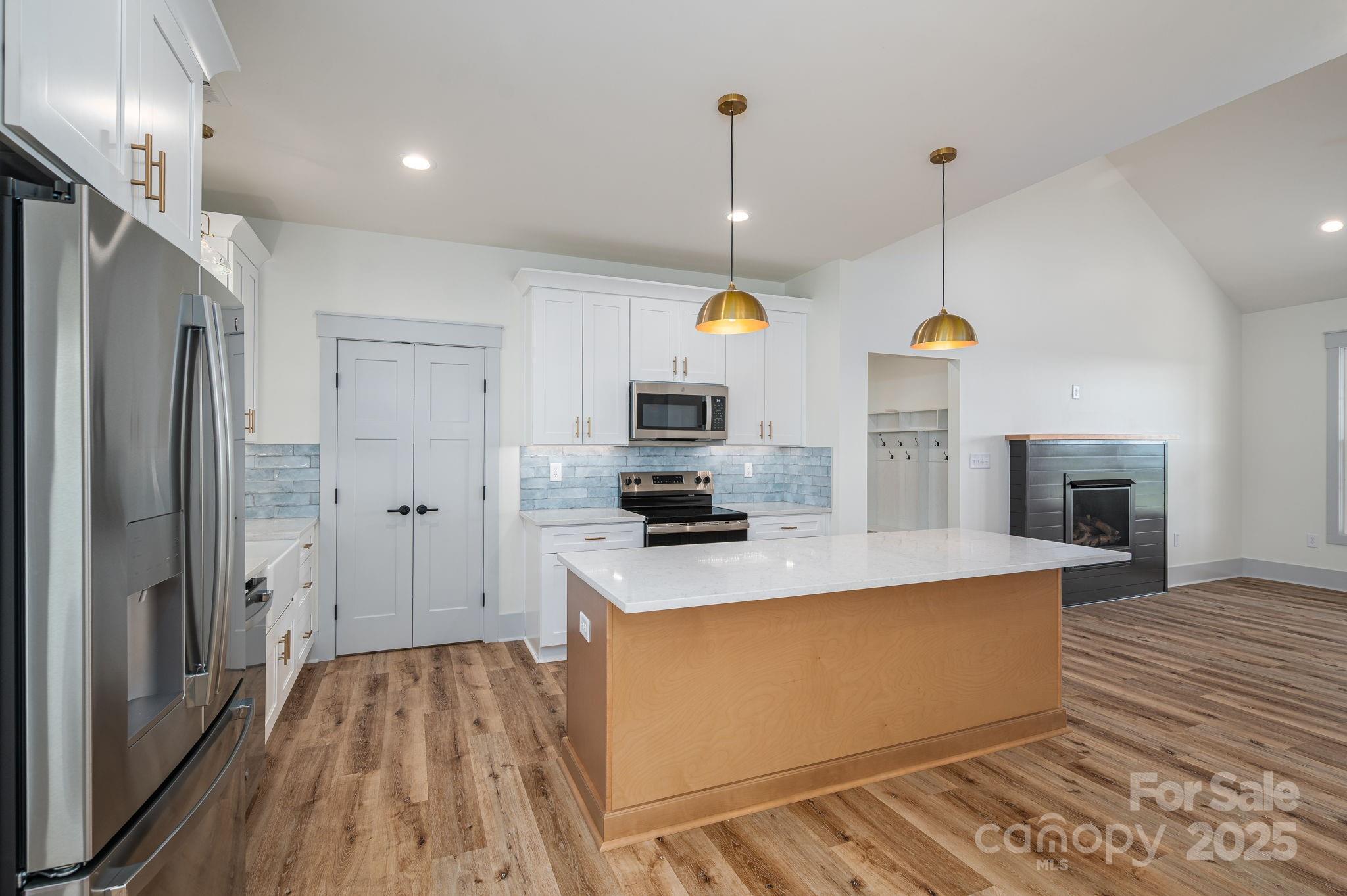 5384 Reepsville Road Vale, NC 28168 - Photo 10 of 44 a view of a kitchen with stainless steel appliances granite countertop a refrigerator a oven and a wooden floors