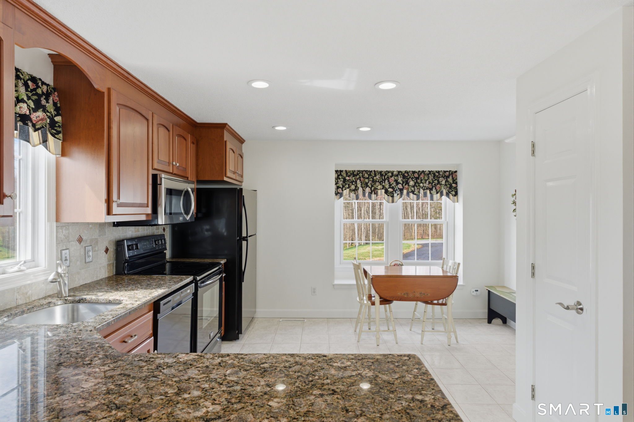 42 Dunham Street, Unit 42 Wethersfield, CT 06109 - Photo 17 of 40 a kitchen with stainless steel appliances granite countertop a stove a sink and a refrigerator