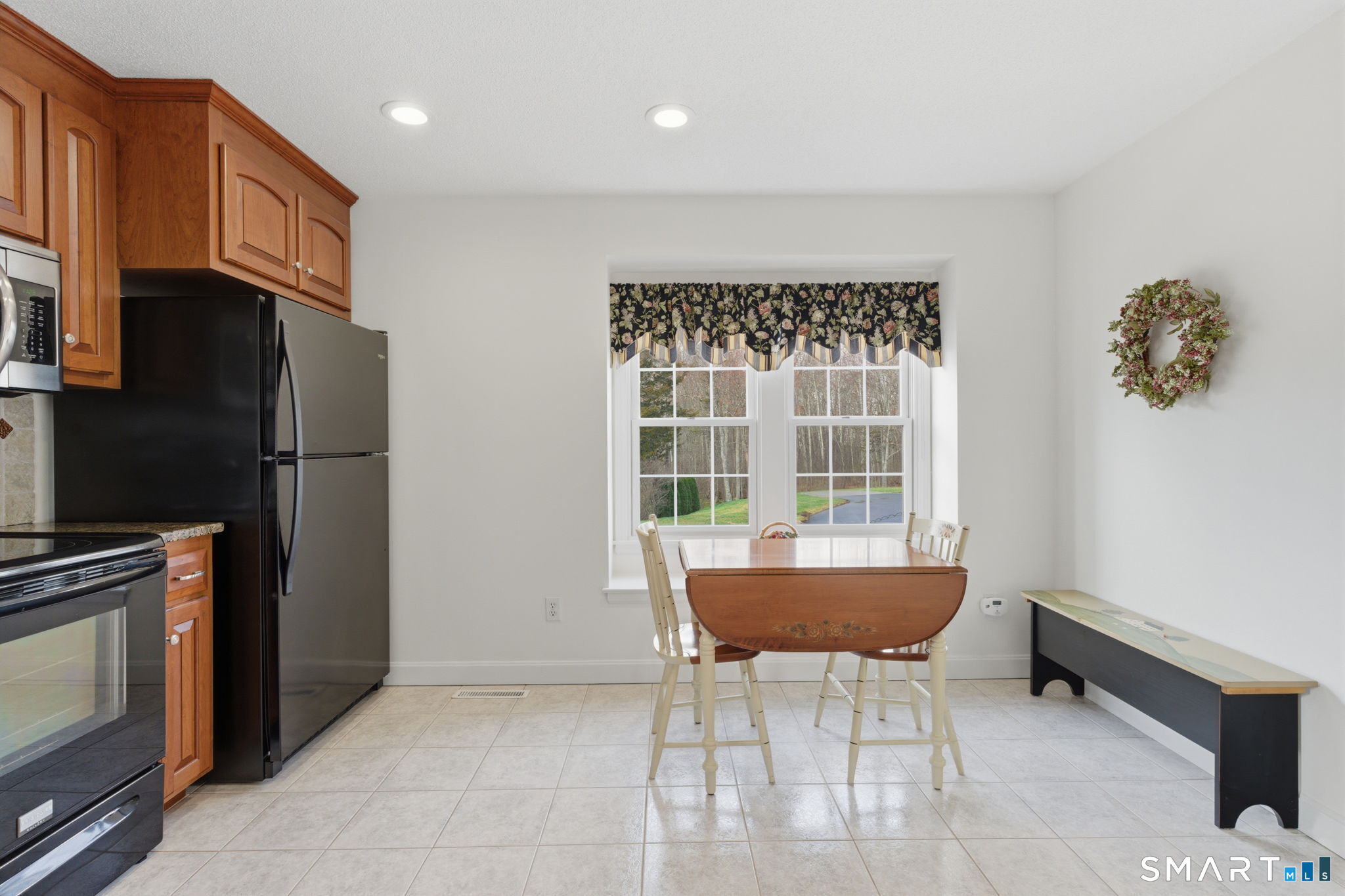 42 Dunham Street, Unit 42 Wethersfield, CT 06109 - Photo 19 of 40 a kitchen with a refrigerator and a table
