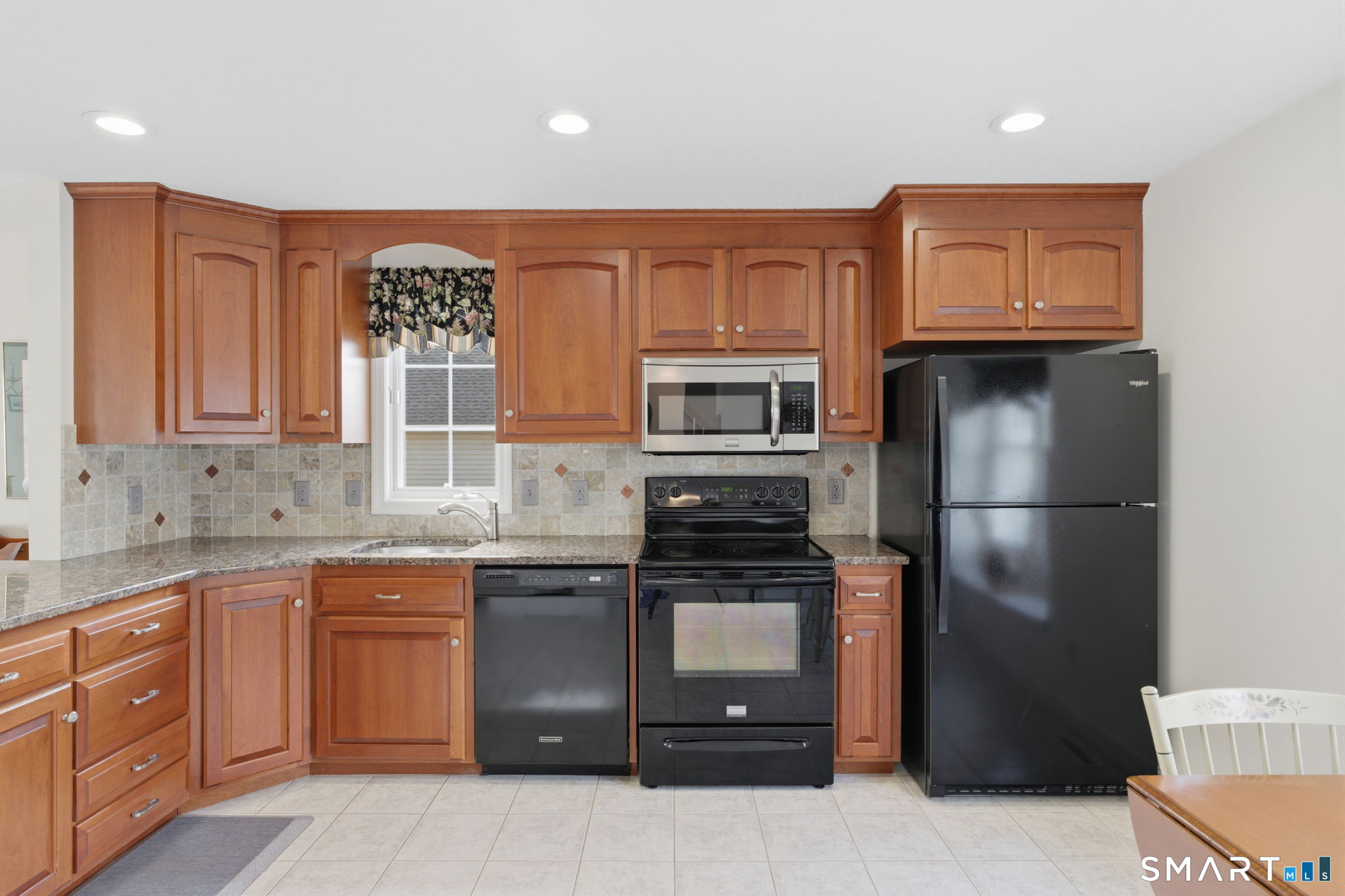 42 Dunham Street, Unit 42 Wethersfield, CT 06109 - Photo 20 of 40 a kitchen with stainless steel appliances granite countertop a refrigerator and a stove top oven