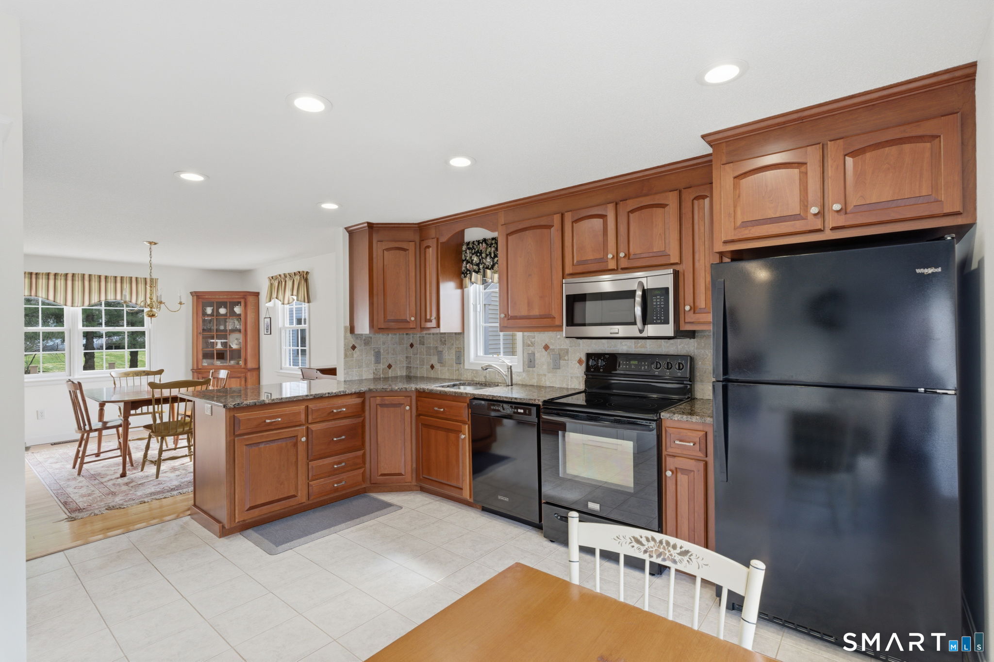 42 Dunham Street, Unit 42 Wethersfield, CT 06109 - Photo 21 of 40 a kitchen with stainless steel appliances granite countertop a refrigerator stove microwave and sink