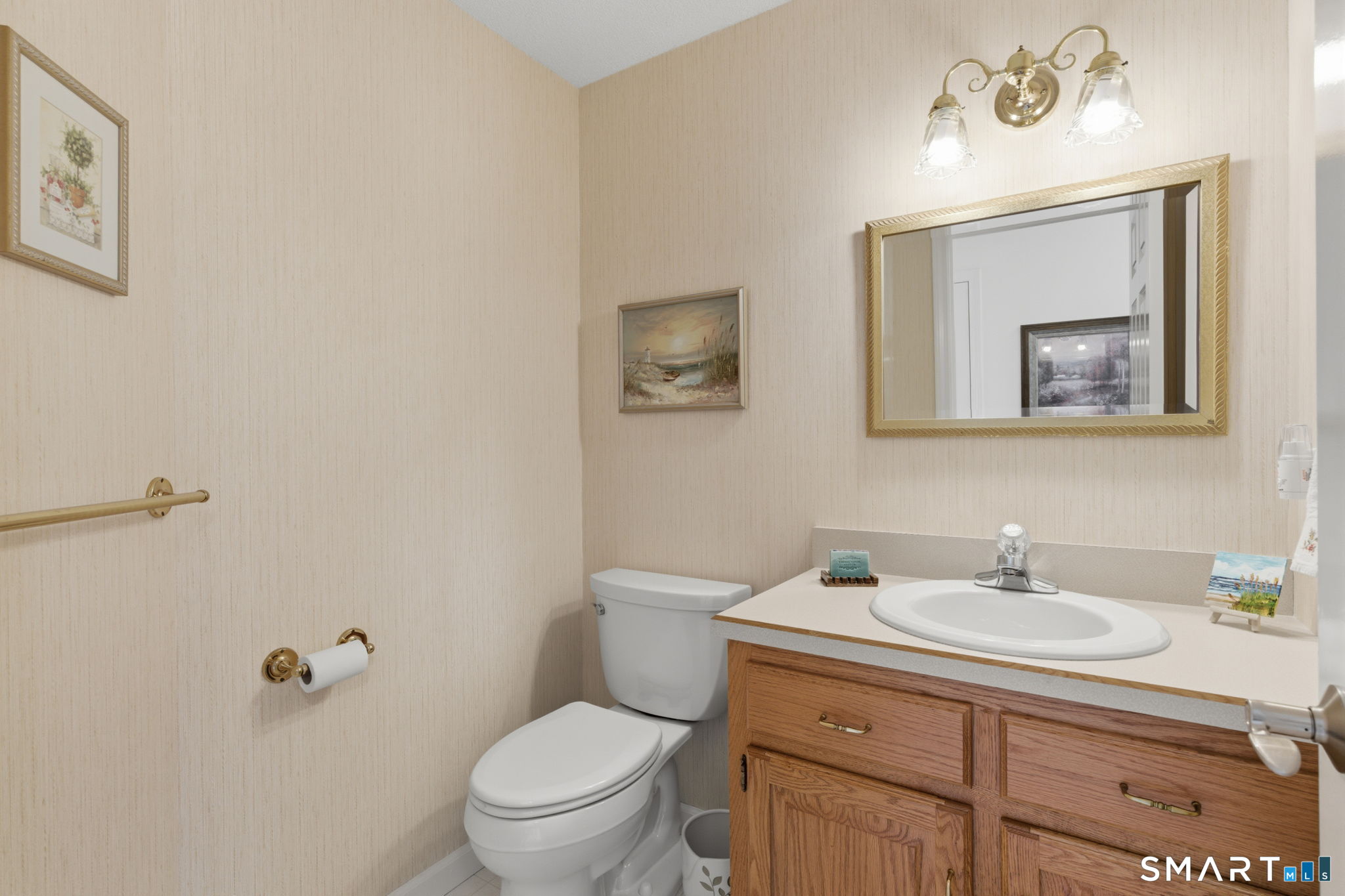 42 Dunham Street, Unit 42 Wethersfield, CT 06109 - Photo 26 of 40 a bathroom with a toilet a sink a mirror and vanity