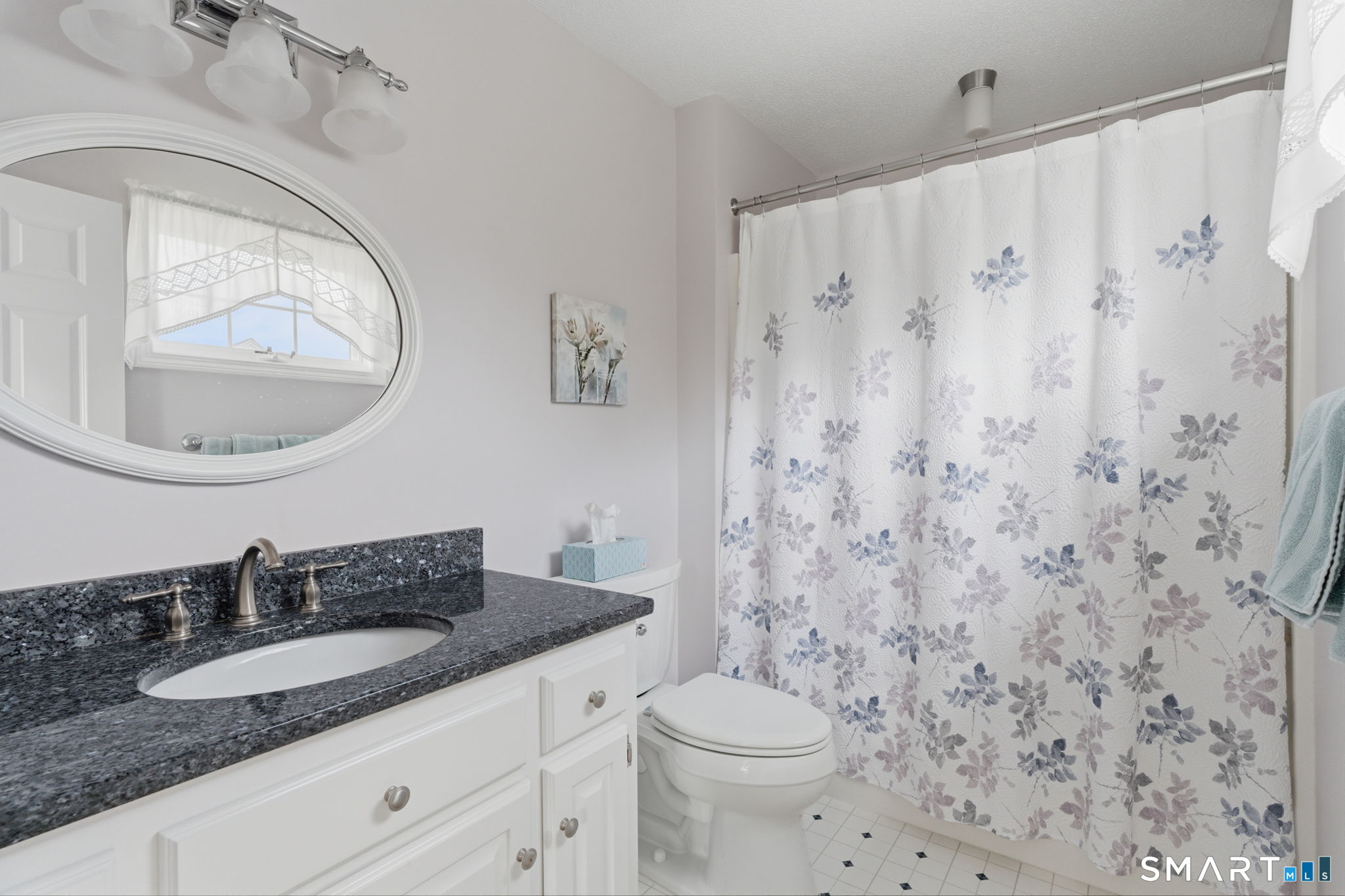 42 Dunham Street, Unit 42 Wethersfield, CT 06109 - Photo 30 of 40 a bathroom with a granite countertop sink mirror vanity and toilet