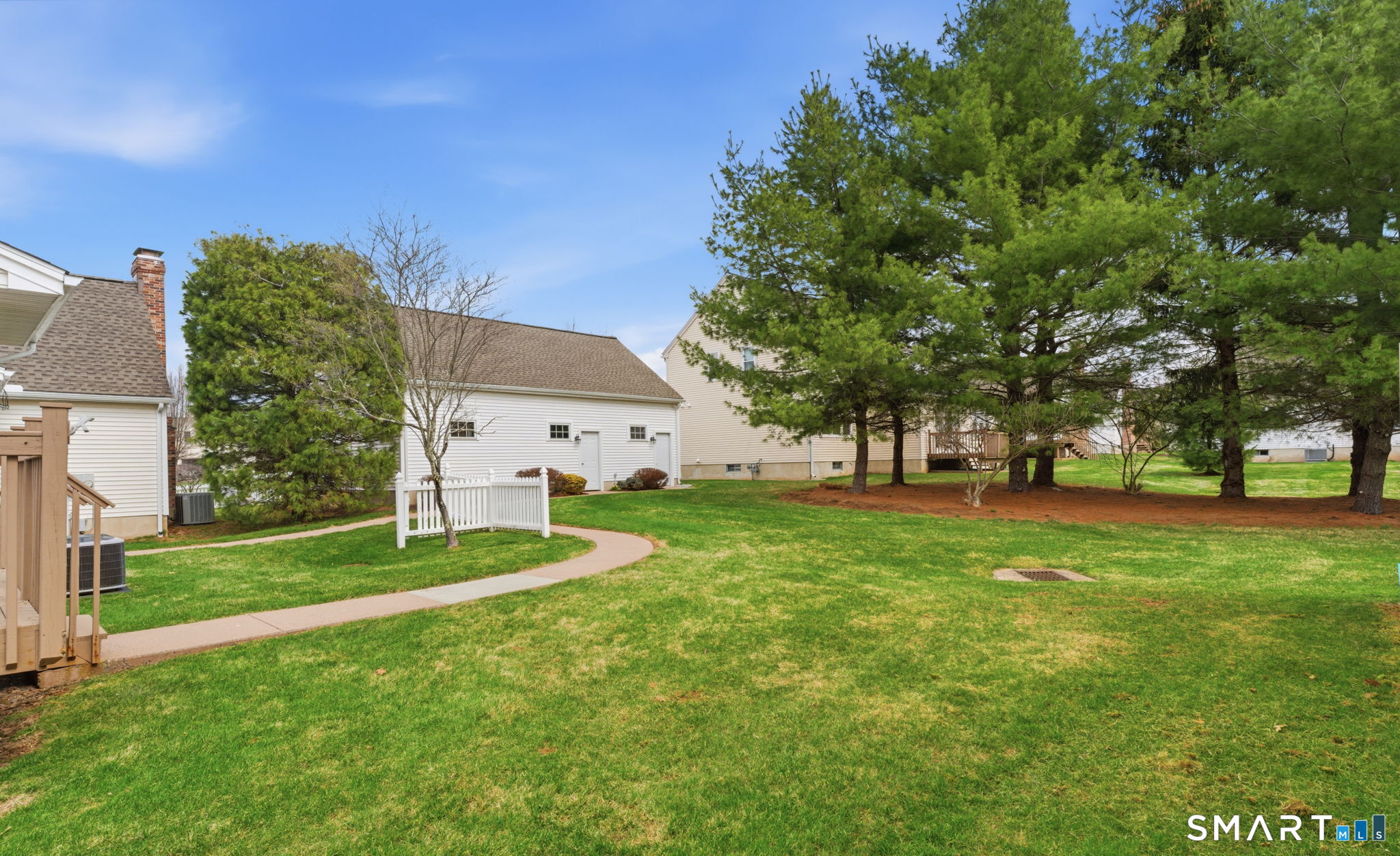 42 Dunham Street, Unit 42 Wethersfield, CT 06109 - Photo 6 of 40 a view of a white house in front of a big yard with large trees
