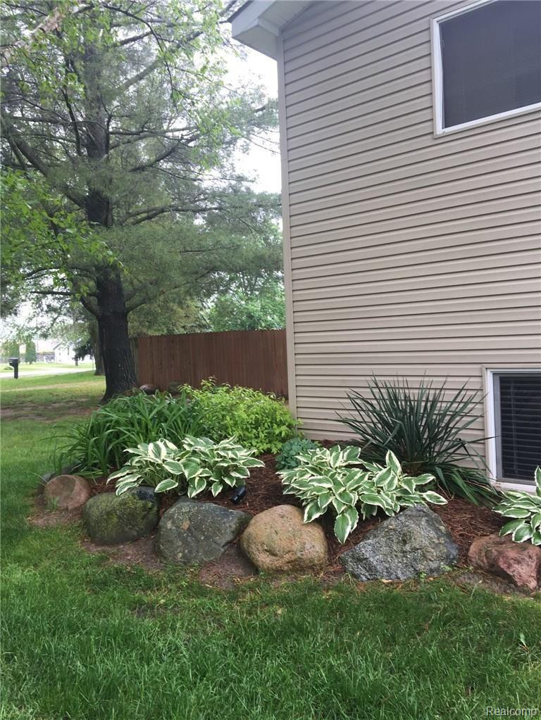 1912 Scheifle Road Walled Lake, MI 48390 - Photo 27 of 29 Lots of boulders in the landscaping.