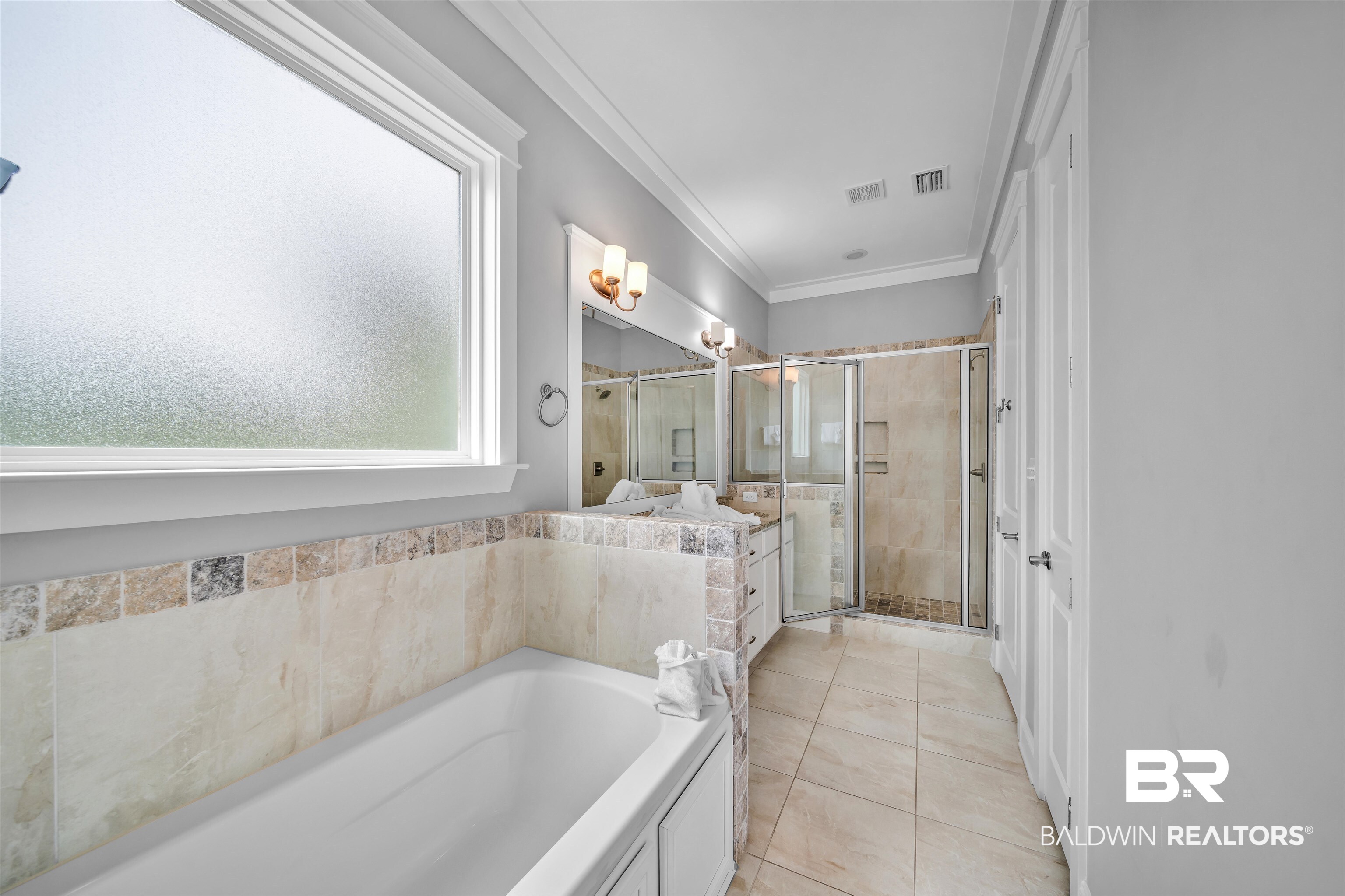 47 Parks Edge Orange Beach, AL 36561 - Photo 13 of 40 Full bathroom featuring crown molding, a bath, a shower stall, vanity, and tile patterned floors