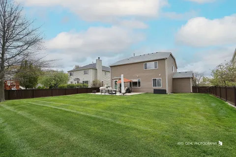 a front view of house with yard and trees